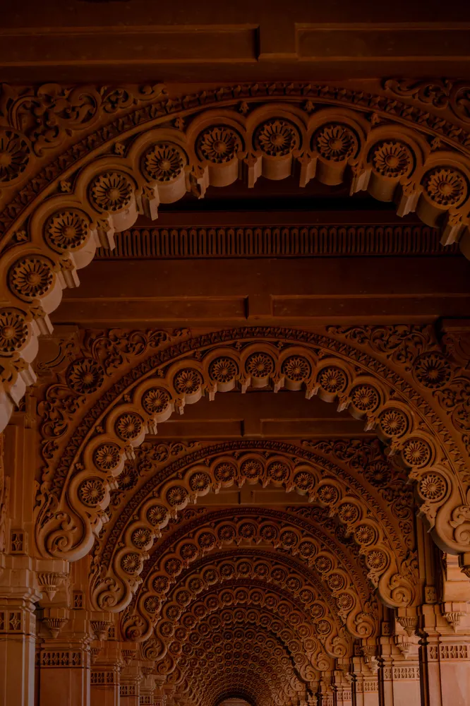 An ornate series of warm golden arches inside a theater